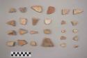 Earthenware vessel rim, body, and foot ring base sherds. Some with red on buff interior, some with red painted exterior, Some with polychrome decoration. One combed/incised rim sherd