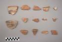 Earthenware vessel rim, base,  and body sherds. Red painted exterior on most. Some with red on white interior. Some with black on red exterior.