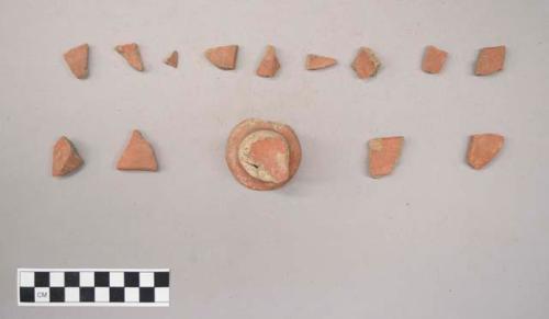 Earthenware vessel rim, body, and pedestal base sherds. Red painted interior and exterior.