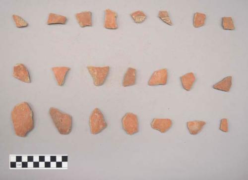 Earthenware vessel body sherds. Red painted exterior. Some with red on white painted exterior. some with polychrome.
