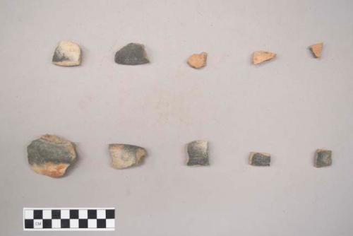 Earthenware vessel rim and body sherds. Some with red painted exterior. Most have charring.