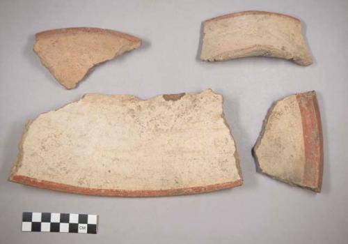 Earthenware vessel rim and body sherds. Most decorated with red  on white painted exterior and interior. Some with red on buff.