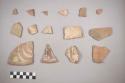 Earthenware vessel body sherds. Some with polychrome interior designs. Some with white painted exterior and one with red painted interior.