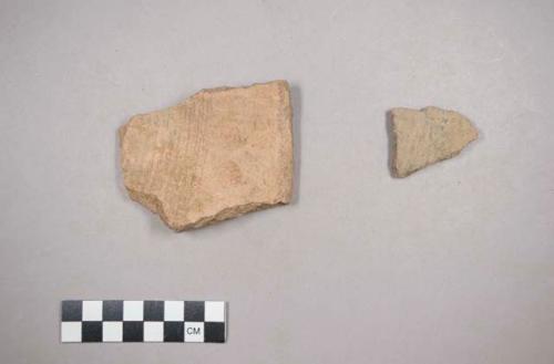 Earthenware unpainted vessel rim, body sherds. decorated with incised lines.