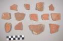 Earthenware vessel body sherds. One with red painted interior and exterior. One with red painter exterior and buff interior. Two with red painted interior and buff exterior. One with red painted exterior and white painted interior