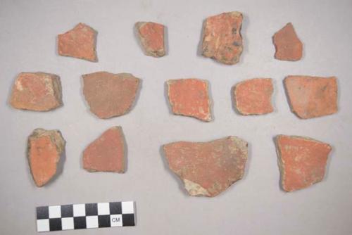 Earthenware vessel body sherds. One with red painted interior and exterior. One with red painter exterior and buff interior. Two with red painted interior and buff exterior. One with red painted exterior and white painted interior