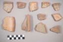 Earthenware vessel rim sherds. Red on buff painted exterior. Red interior. Some charred.