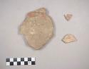 Earthenware vessel body and foot ring base sherds. Red painted interior.