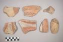 Earthenware vessel rim, body, and base sherds. Most with red on white painted exterior and red interior. Some with red and black on white exterior and red interior.