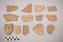 Earthenware vessel rim and body sherds. Red painted interior and exterior.