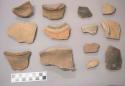 Earthenware vessel rim, base, and body sherds. Most with red painted exterior decoration. Some with incised dentate decoration. One charred sherd.