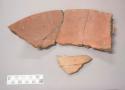 Earthenware vessel rim and body sherds. Red paint interior and exterior.