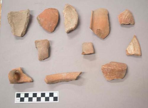 Earthenware vessel rim, body, and base sherds with polychrome paint decoration on exterior. Some loop handle sherds. Some shoulder fragment sherds.