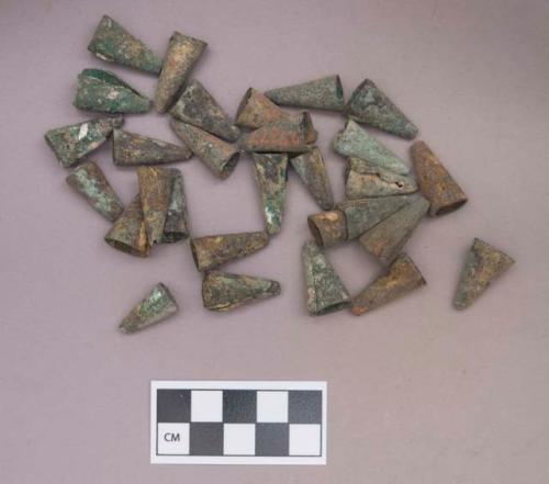 Metal, copper alloy rolled cones, tinklers; shell beads and bead fragments, some adhered to tinklers