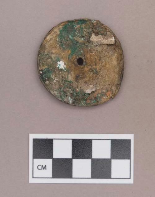 Metal, copper alloy ear spool fragment, with shell or bone adhered to one side