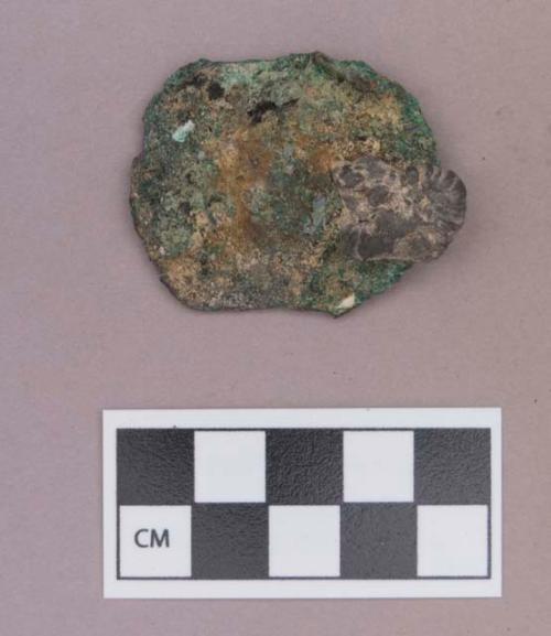 Metal, copper alloy ear spool fragment, with possible stone adhered to one side