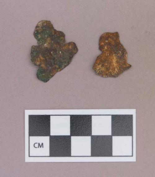 Metal, copper alloy sheet fragments, worked, one perforated