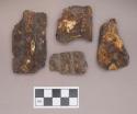 Metal, worked iron sheet fragments, with rolled edges, two with grooves, one with shell fragment adhered, one with rolled copper alloy tinkler cone adhered; four fragments crossmend