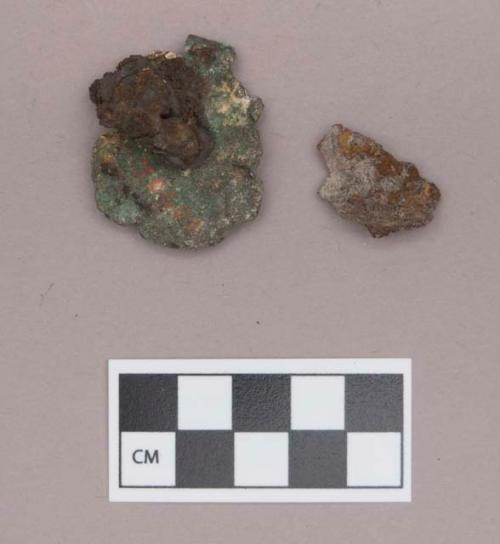 Metal, copper alloy ear spool fragment, with charcoal, mica, and iron adhered to it; iron fragment with charcoal adhered to it