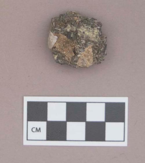 Galena fragment, with shell fragment adhered to it