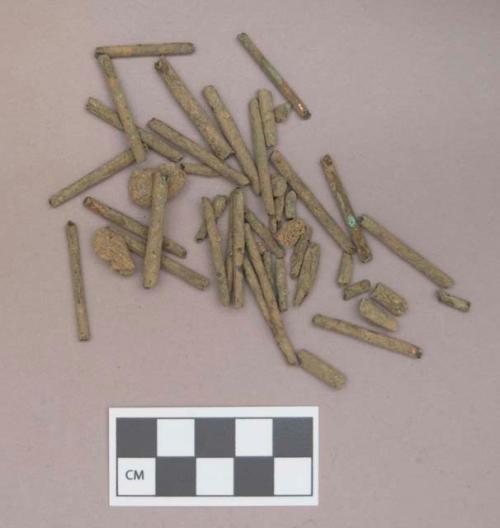 Metal, copper alloy rolled tubular beads; soil fragments