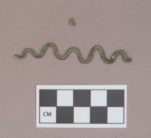 Metal, copper alloy ornament, snake or serpent shaped, with a loop at one end; copper alloy fragment