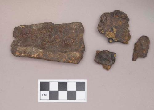 Metal, iron adze fragment and unidentified fragments; three fragments crossmend