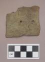 Metal, copper alloy sheet fragment, cut, with two perforations