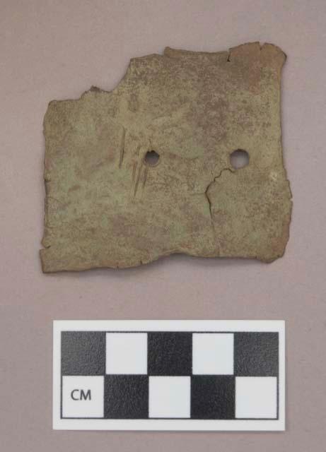 Metal, copper alloy sheet fragment, cut, with two perforations