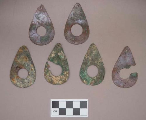 Metal, copper alloy pendants, flat, teardrop shaped, with hole in center, one with mica and stone adhered to it