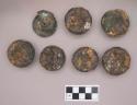 Metal, copper alloy ear spools and ear spool fragments, each with iron on one side
