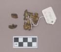 Metal, copper alloy sheet fragments, with perforations; three fragments crossmend