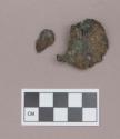 Metal, copper alloy ear spool fragment, folded; two fragments crossmend