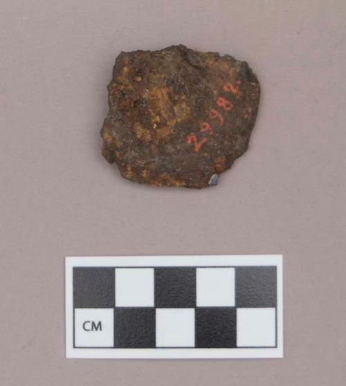 Metal, iron ear spool fragment