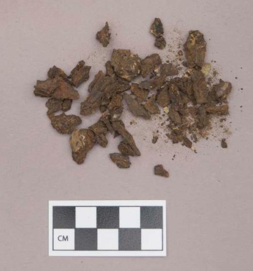 Metal, iron fragments; paper fragments, one green