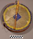 Drum, hide with colored pigment, and drumstick