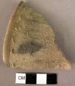 Rim sherd-grey burnished on inside-outside finger-smeared in petal design;