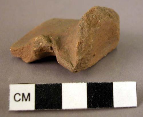 Pottery handle fragment - red slipped