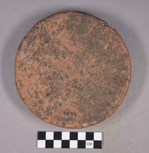Ceramic, earthenware complete vessel, footed, circular, and flat, undecorated, possible stool