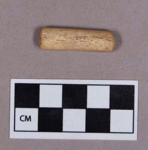 Organic, utlized antler, cylinder-shaped with flat ends, possible punch