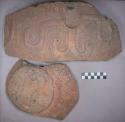 Earthenware body and base sherds with carved designs