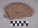 Earthenware disk base sherd with incised designs