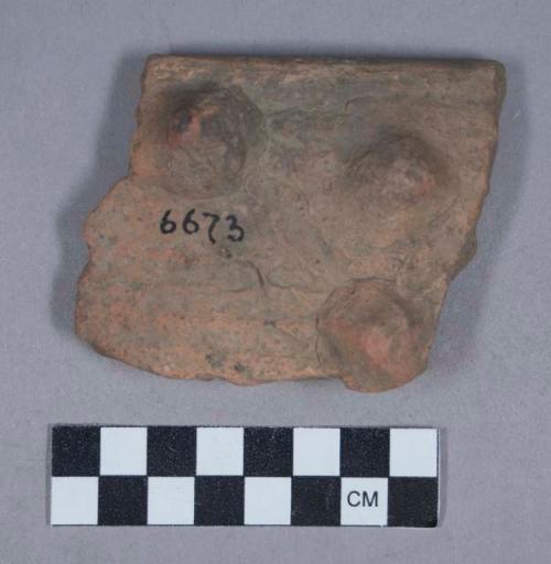 Earthenware rim sherd with three modeled knobs