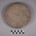 Earthenware disk with pedestal base and incised designs