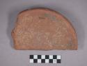 Earthenware base sherd with incised designs and pedestal base