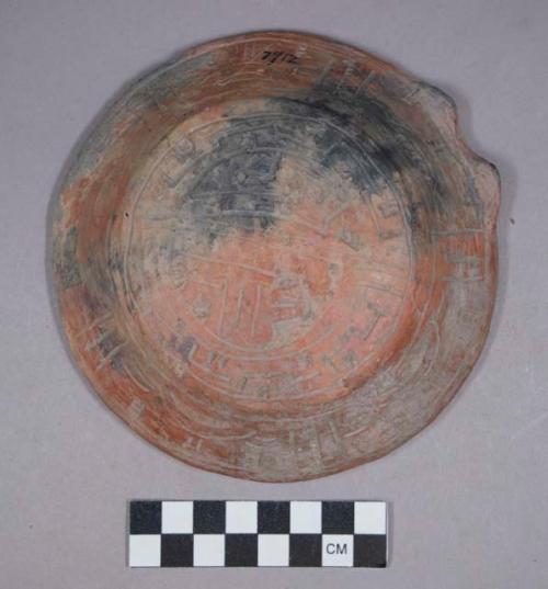 Earthenware complete dish with incised designs on exterior