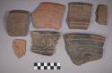 Earthenware rim and body sherds with carved and incised designs