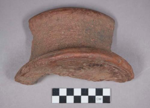 Earthenware disc sherd with carved designs on flat surface