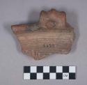 Earthenware rim sherd with modeled handle and incised designs on rim and body