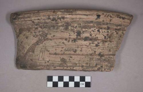 Earthenware rim and body sherd with incised designs